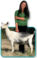 A woman standing with a goat.