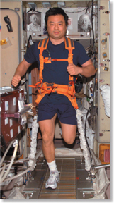 An astronaut running on a treadmill.