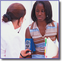 A doctor measures a woman's blood pressure.