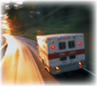 An ambulance travelling at speed on a road.