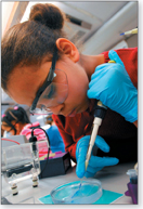 A lab technician examining a specimen.