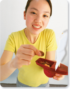 A lady holding a prototype of toy boat.