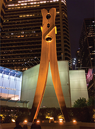  A large sculpture of a clothespin in the city of Philadelphia at night with lights on the ground. 