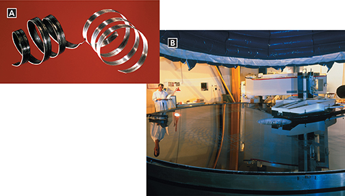 Two photos labeled A and B. Image A shows a closeup of magnesium and aluminum coils, side by side. Image B shows a large telescope mirror in a lab, with a male scientist standing next to it as he operates it.