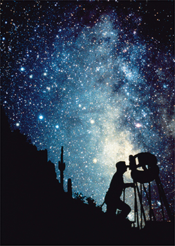 A starry night sky with the silhouette of a man looking through a telescope.