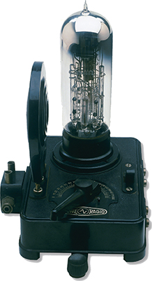 A machine with a solid base and a glass tube sticking up at the top. 