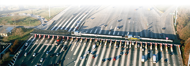 An aerial view of highway traffic at a toll both.