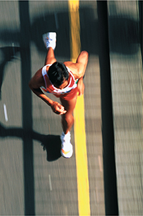 An aerial view of a man running on the road.