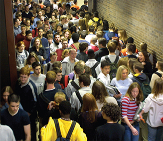 Students walk in a crowed corridor. 