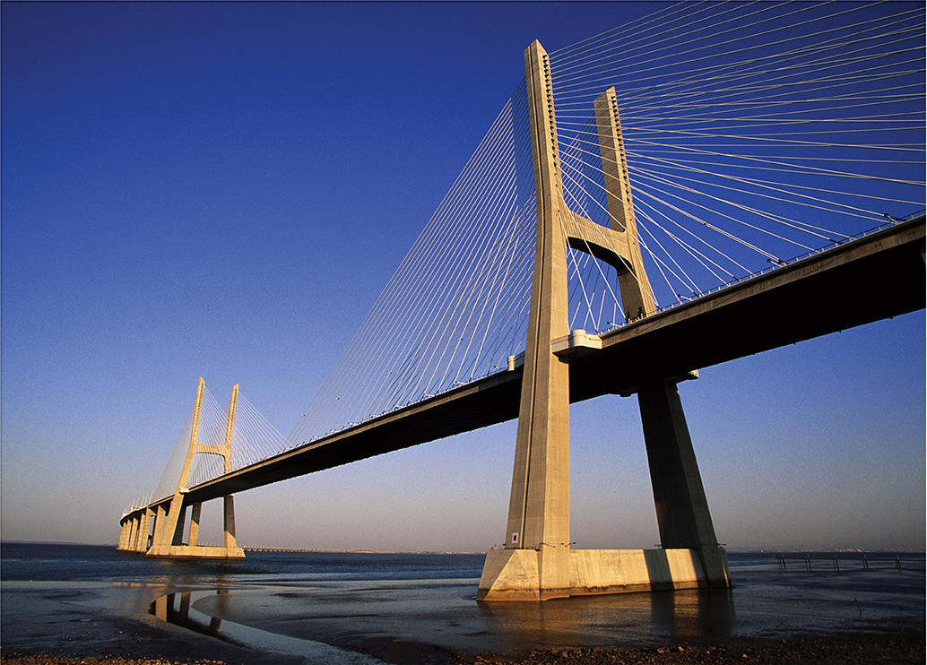 Photo of a large industrial bridge over water. 
