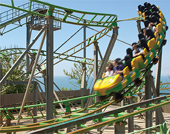 Photo of a rollercoaster accelerating as it moves faster down the track.