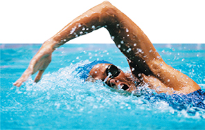 A swimmer in mid stroke in a pool of water.  