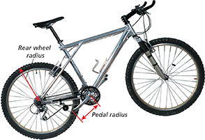 A bicycle with arrows pointing to the rear wheel radius and the pedal radius.