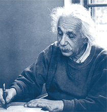 Albert Einstein, in the process of writing on a piece of paper.
