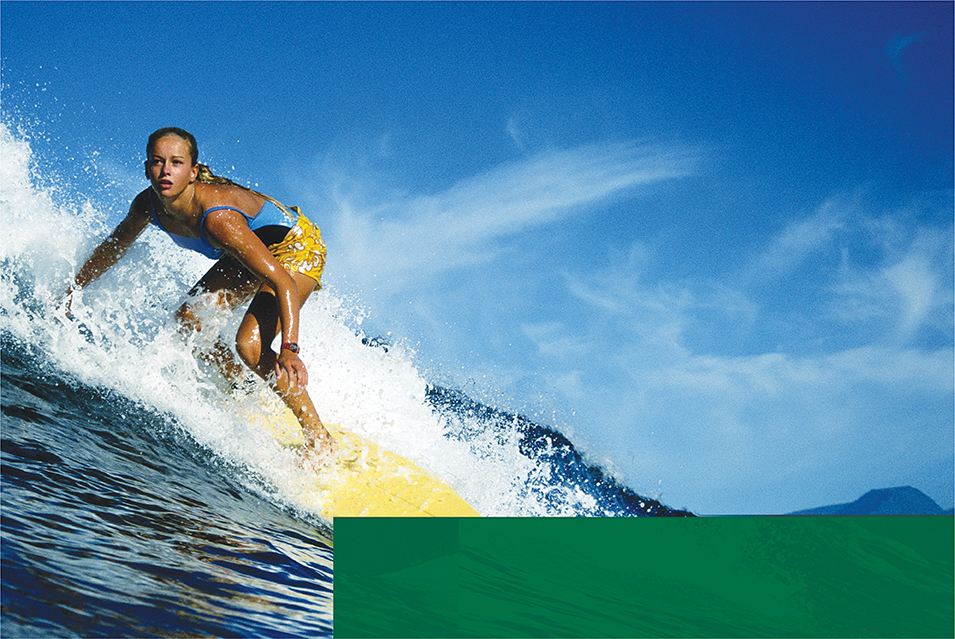 A female surfer riding an ocean wave.  