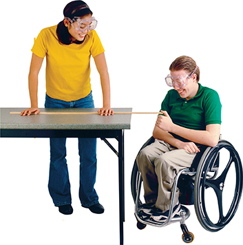 Two female students using a meter stick in a lab experiment.
