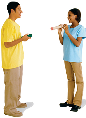 Two students using a flash light and card board tubes in a lab experiment.