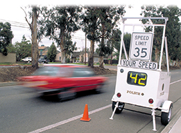 A car speeds past a radar operated speed detector. The car is driving 42 mph in a 35mph zone.