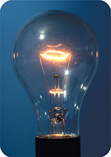 An incandescent light bulb that is on.