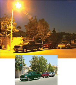 The photo taken of cars on a street.  One taken in daylight and another under a sodium vapor street lamp.  The color of the vehicles have been altered in the photo taken under the sodium vapor light.