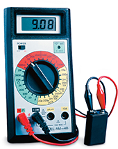 A  multimeter measuring the voltage of a battery. 