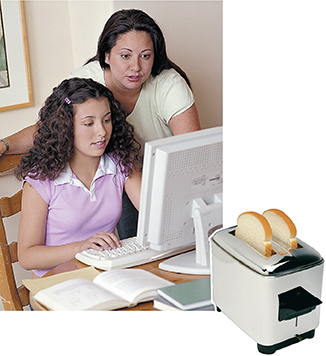 An electronic device (mother with daughter at the computer) and an electrical device (toaster).  Both use electric current, but in different ways. 