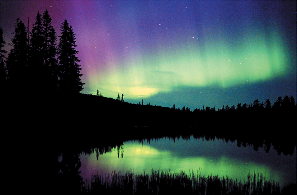 A  colorful night sky created by the Aurora borealis, the northern lights.
