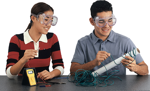 A boy and girl student performing the lab experiment for this section.