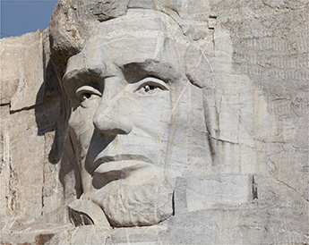 Abraham Lincoln's face carved into the granite of Mount Rushmore.  