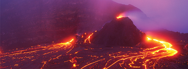 Lava flowing out and down the sides of a volcano that had a quiet eruption.  