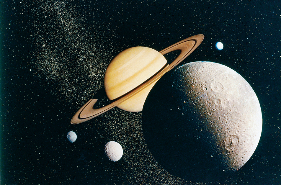 Saturn  and its four moons in space with stars in the backgrounds. 