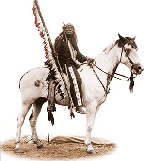 A Native American holding a long, feathered pole and is astride a white horse.