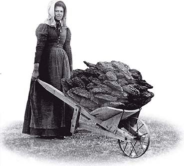 A photo of a girl pushing a full wheelbarrow