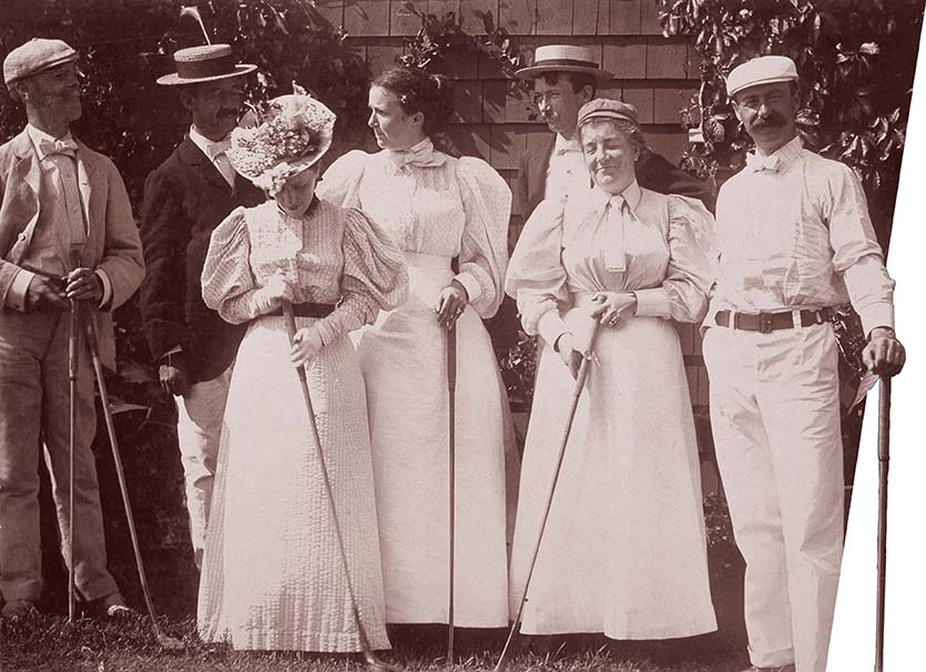 Several prosperous men and women holding golf clubs.