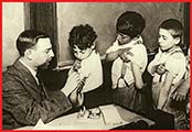 A photo of children lined up to get vaccinations.