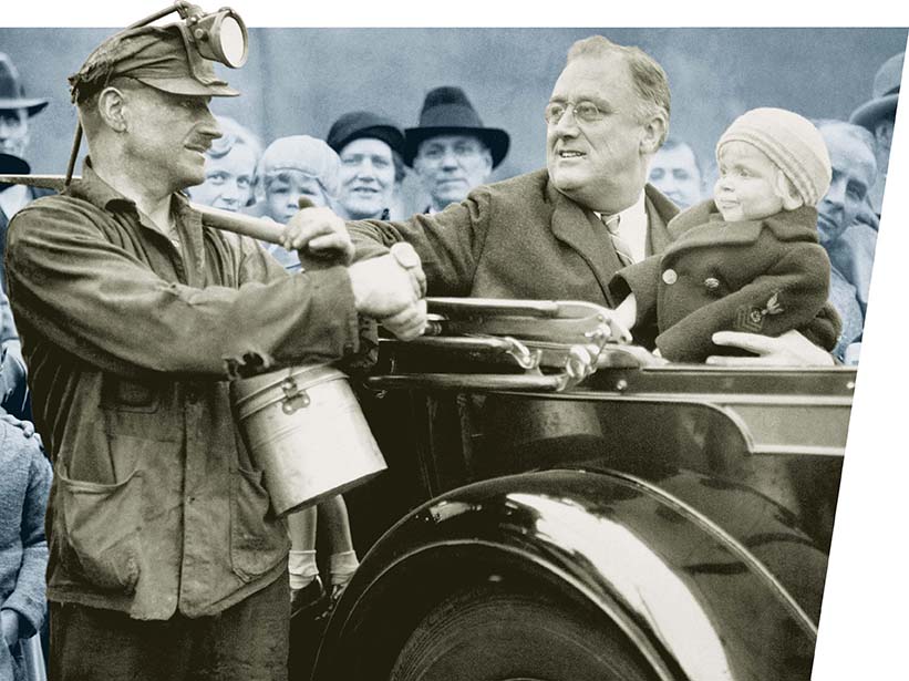 President Franklin D. Roosevelt shakes hands with a coal miner.