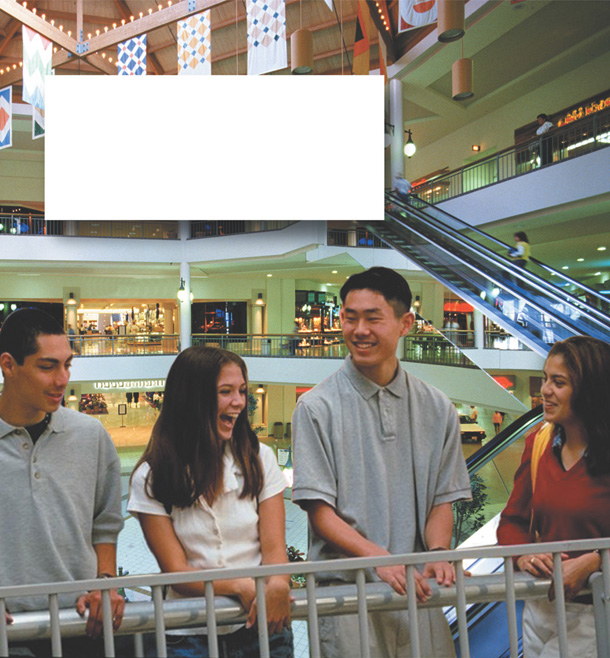 A group of people are smiling in a mall.