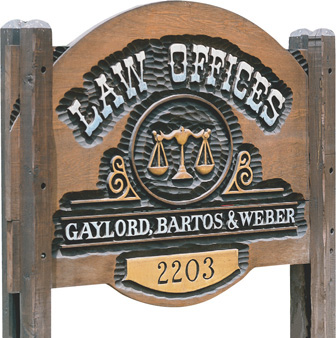 A wooden sign reads, “Law Offices: Gaylord, Bartos and Weber.”