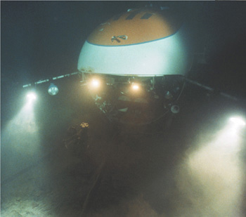 A high-tech underwater camera operates near the ocean floor.