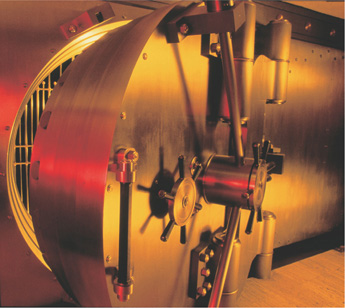 A photo of a bank vault with its door slightly open.